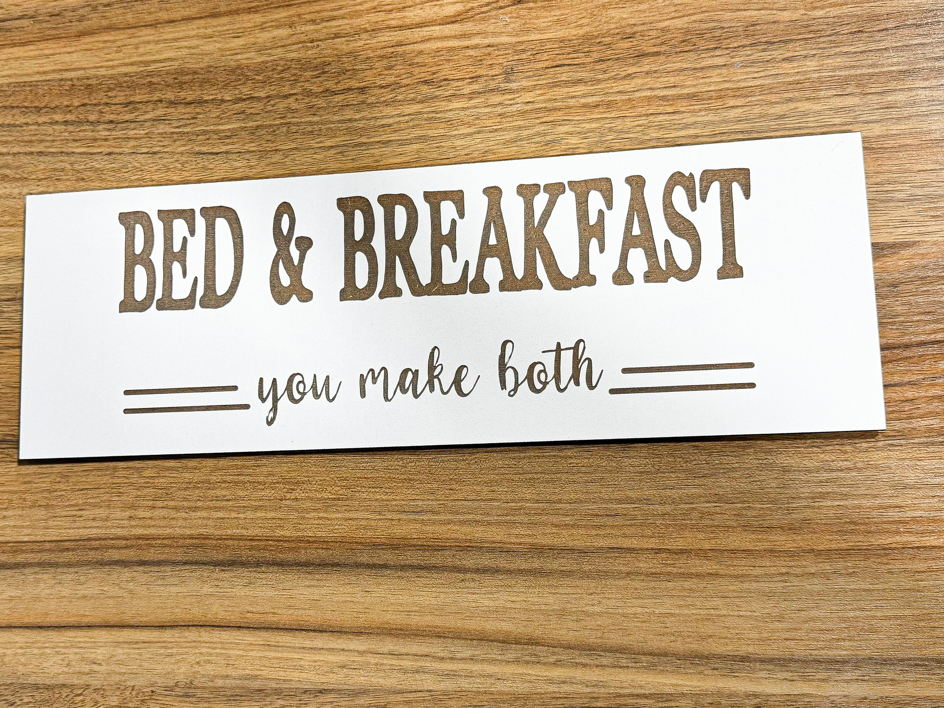a bed and breakfast sign on a wooden table