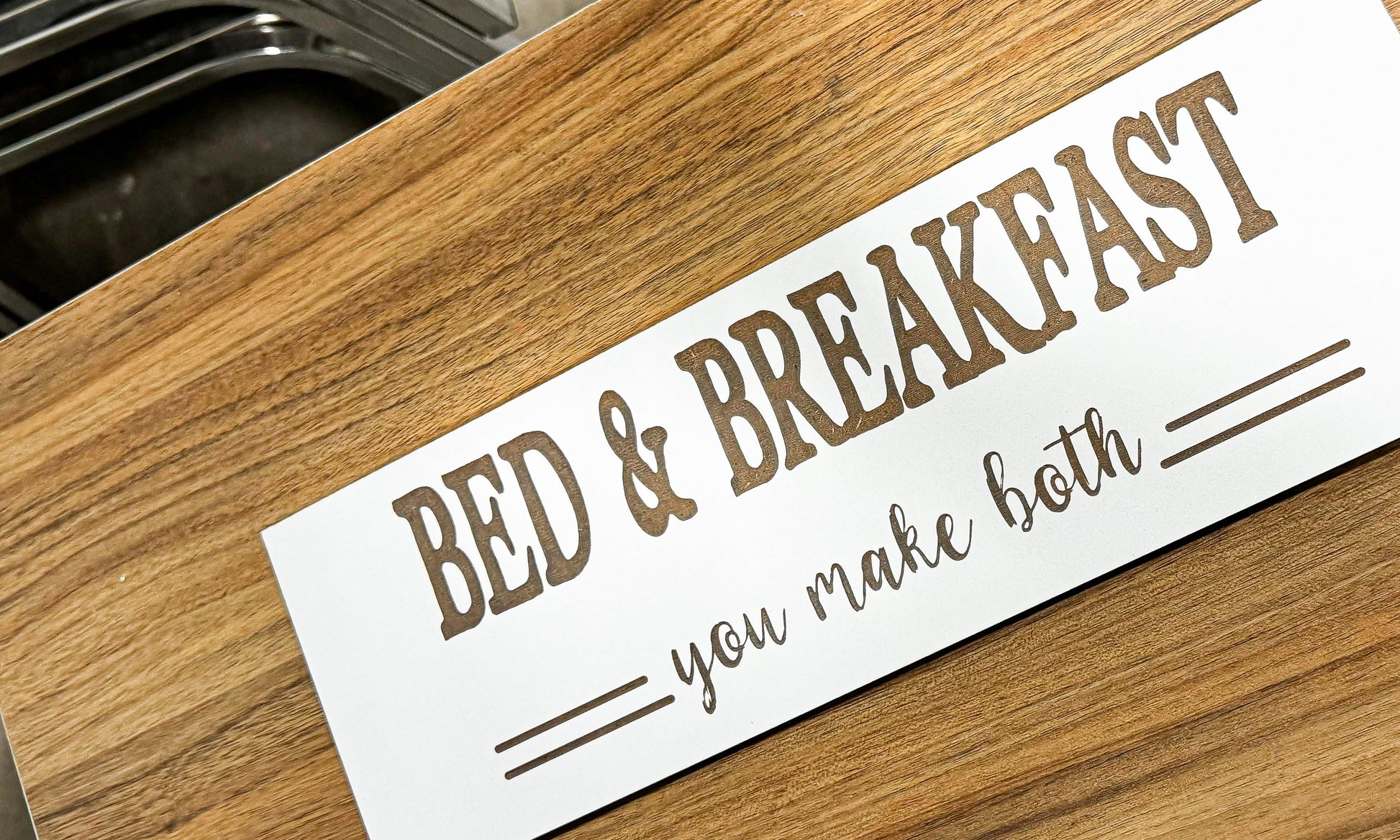 a bed and breakfast sign sitting on top of a wooden table