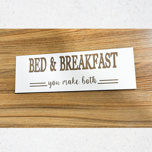 a bed and breakfast sign on a wooden table