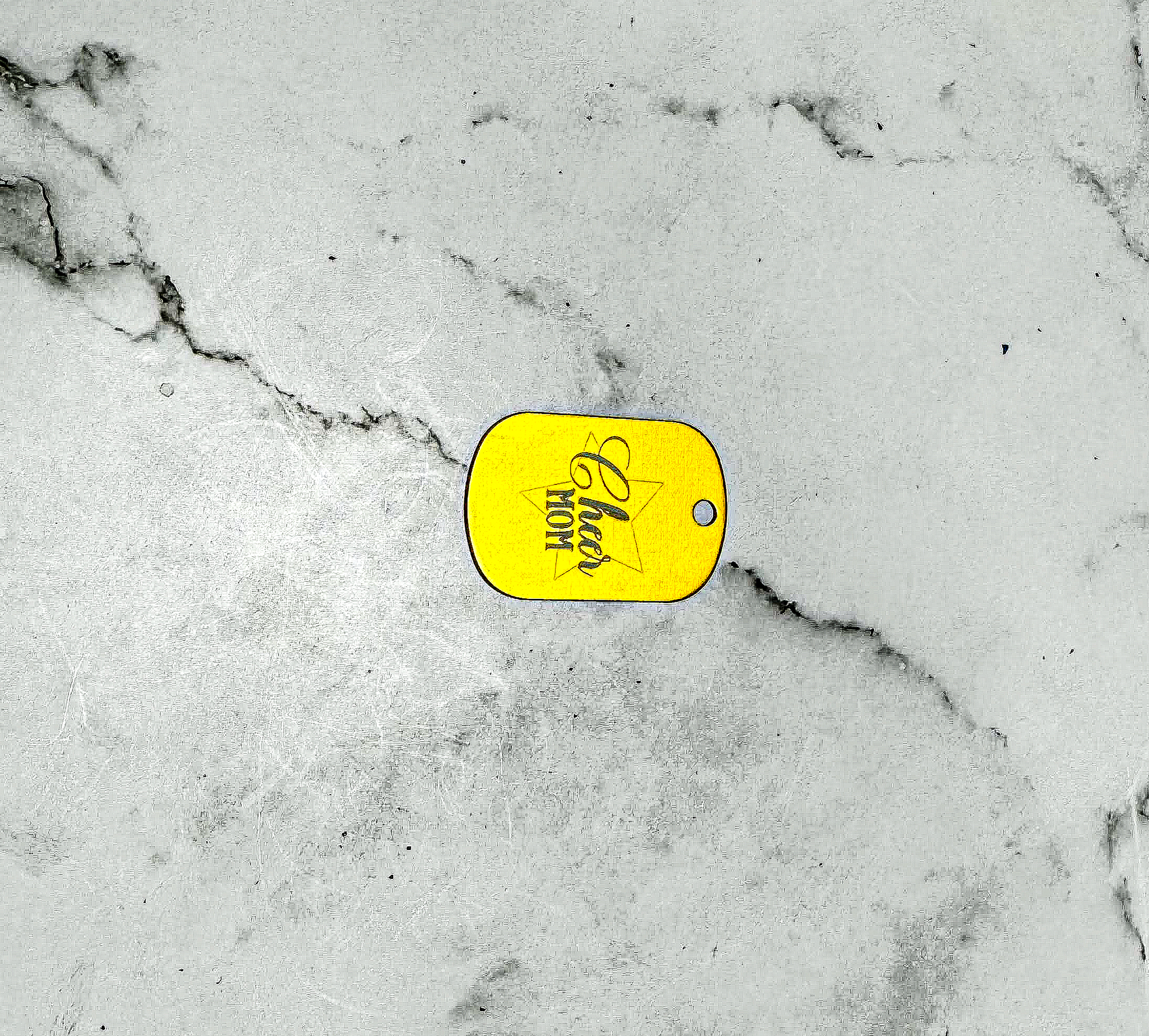 a yellow tag on a white marble surface
