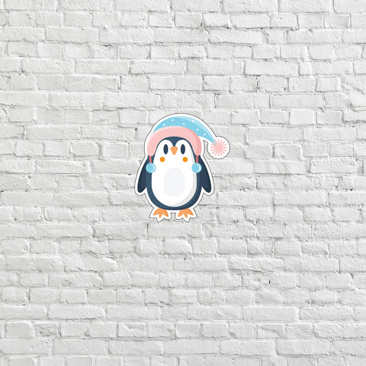 a penguin with a pink hat on a white brick wall