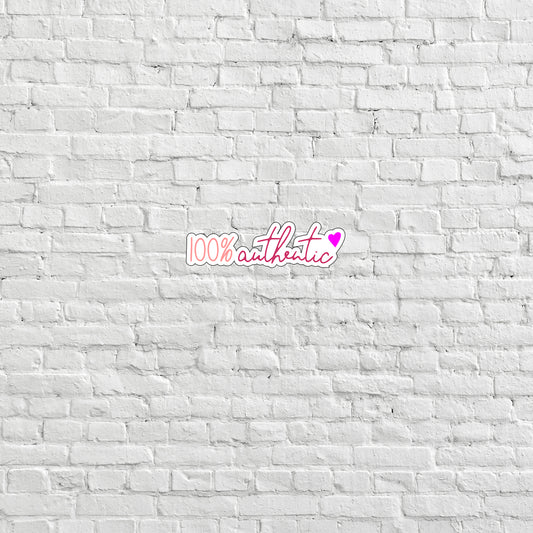 a white brick wall with a pink sticker on it