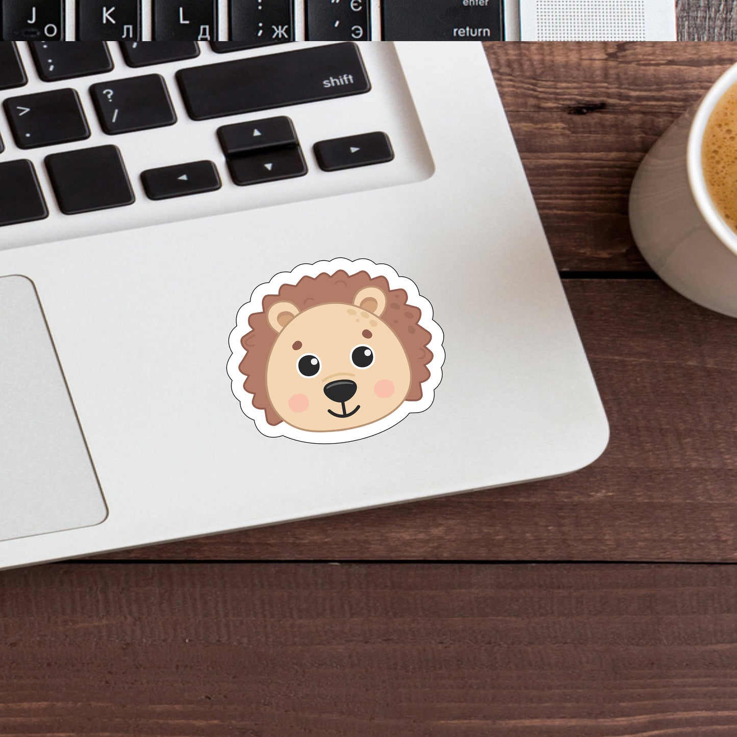 a cup of coffee and a sticker of a lion