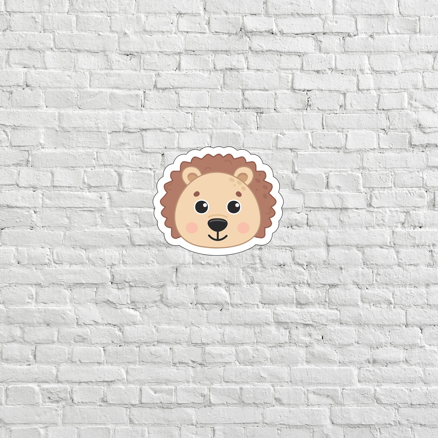 a sticker of a lion on a white brick wall
